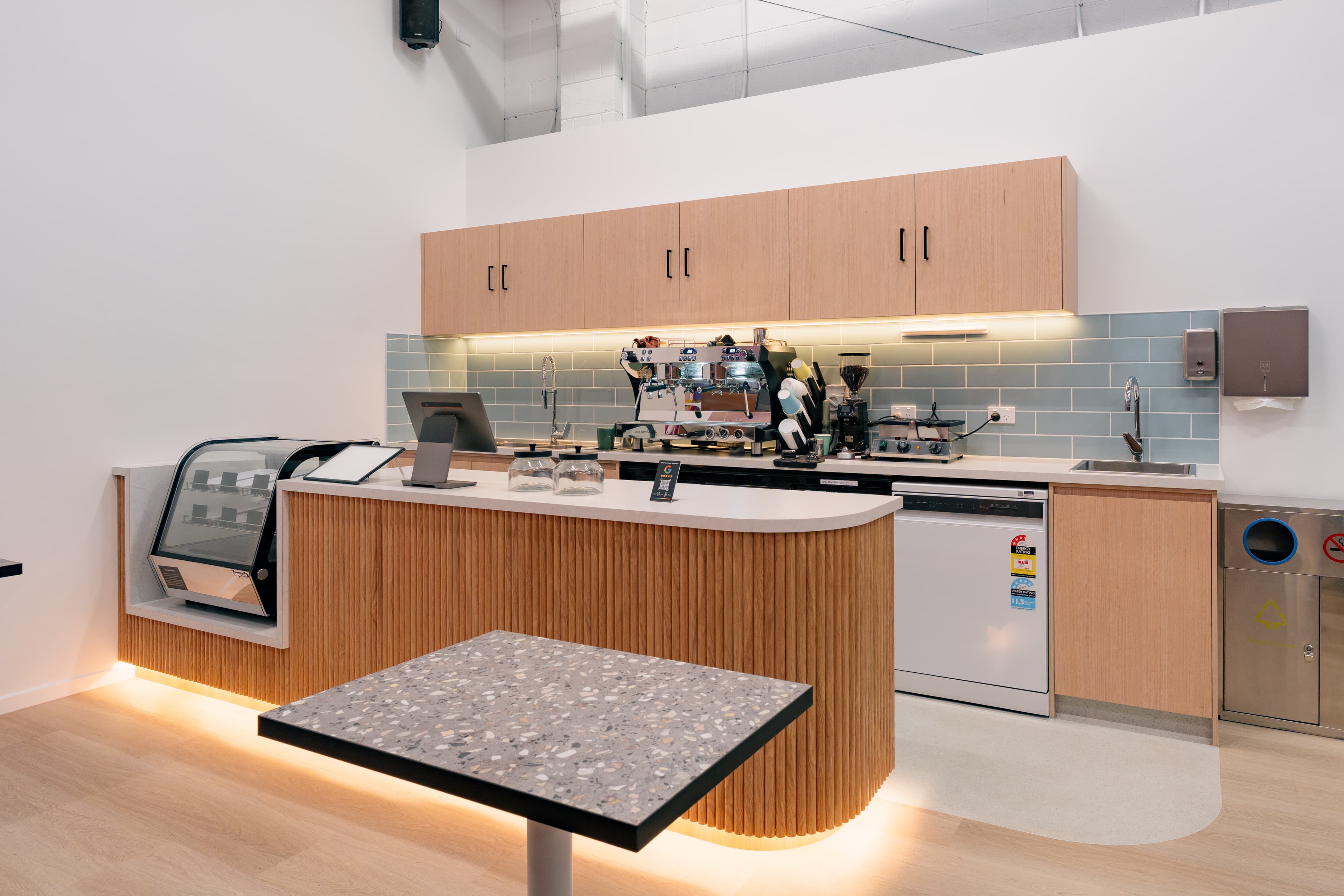 A cafe seating corner where adults can relax while staying connected to the nearby play space.